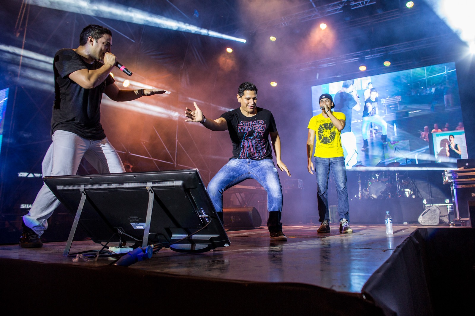 Black and white portrait of a dance instructor posing in front of a dark background.